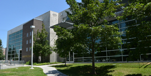 A building with trees in front.